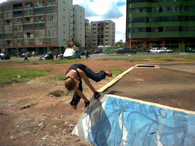 a person doing tricks on a skateboard at a skate park