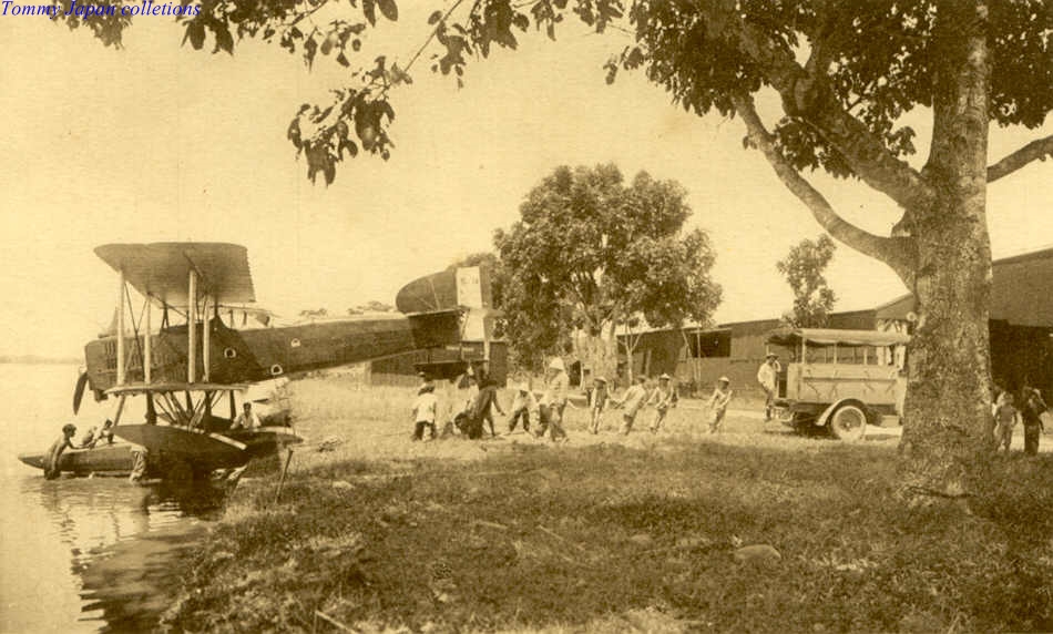 vintage black and white pograph of people near an old air plane