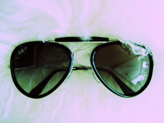 a pair of sunglasses with a white fur covering them