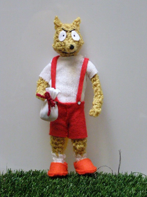 a stuffed animal that is wearing a red and white suit
