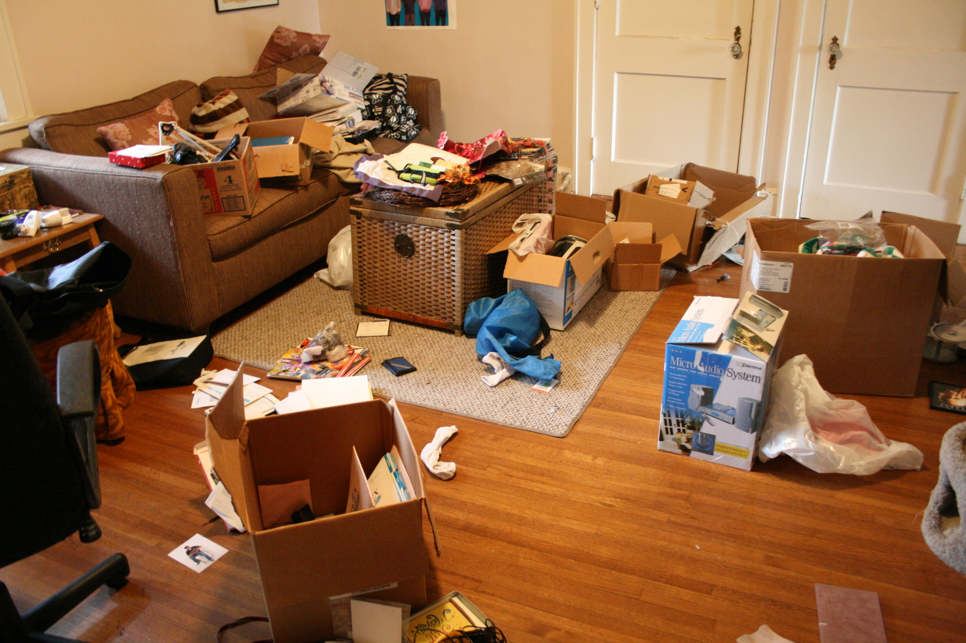 the living room is filled with boxes and other household items