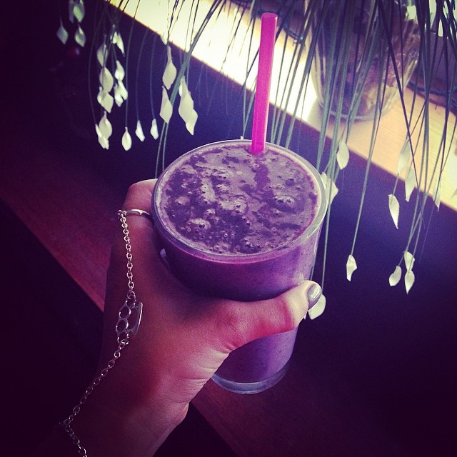 the hand is holding the beverage, which was dyed with purple color
