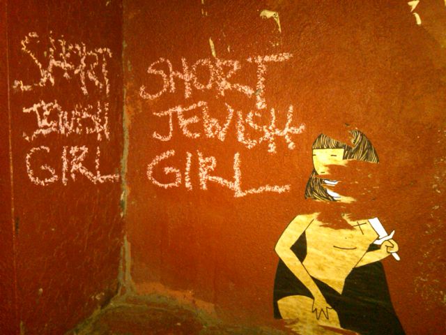 the graffiti is written on the wall by the girl
