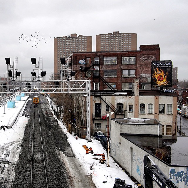 a snow covered train track in a city