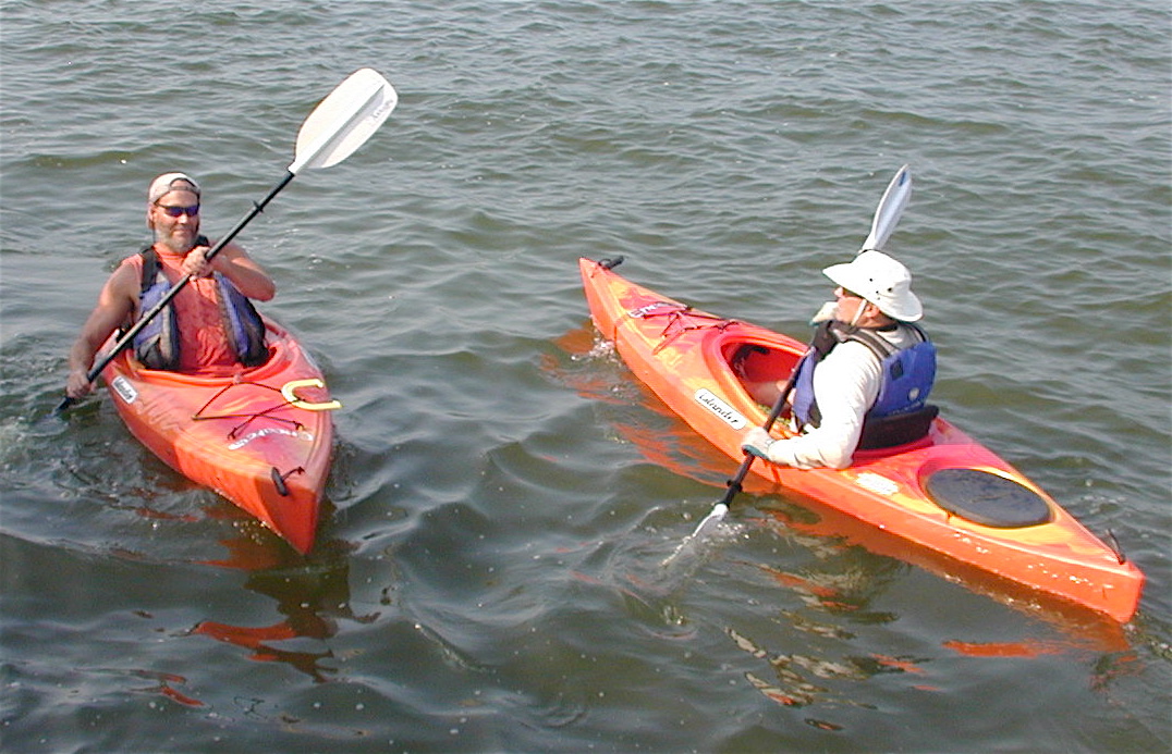 two people are on kayaks with paddles