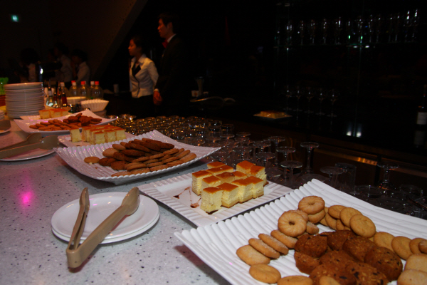 table topped with cookies and pastries on trays