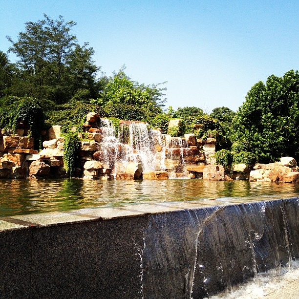 an artificial waterfall surrounded by two large rocks