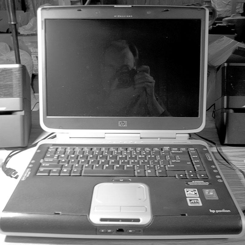 a laptop sits on a desk in front of other equipment
