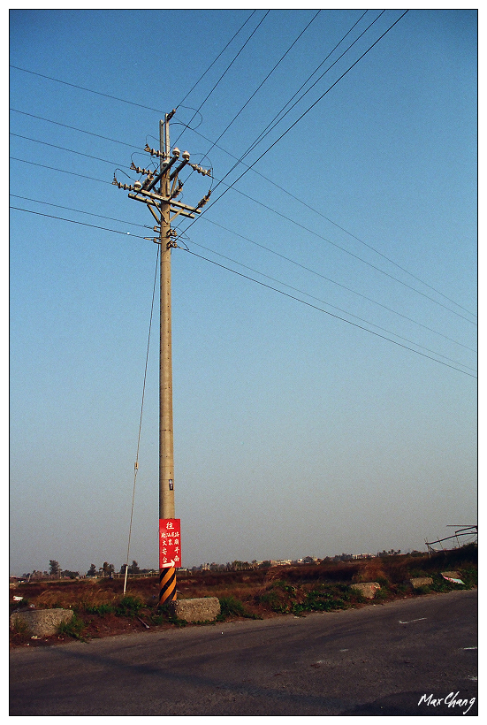 a power pole with a red sign that reads stop