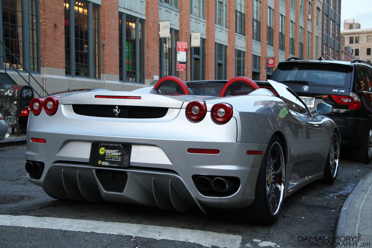 a silver sports car parked on the side of a road