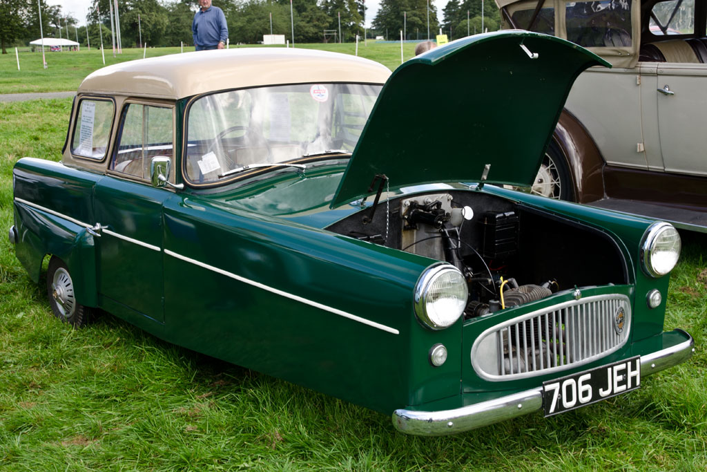 the classic car was parked on the grass