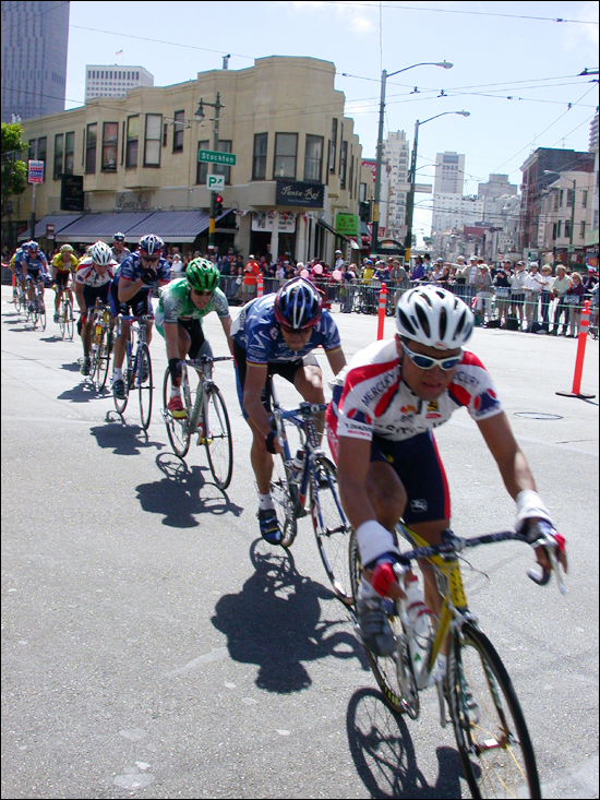 a number of bicyclists going on a street