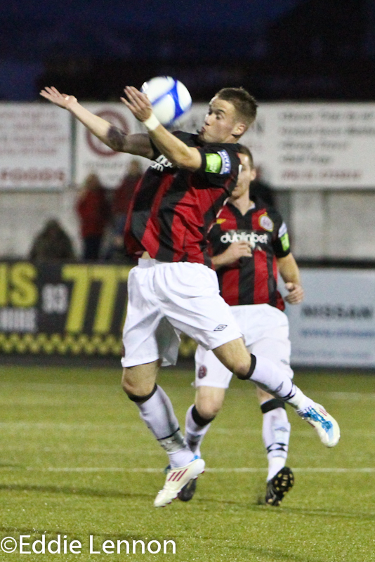 two soccer players are playing against each other