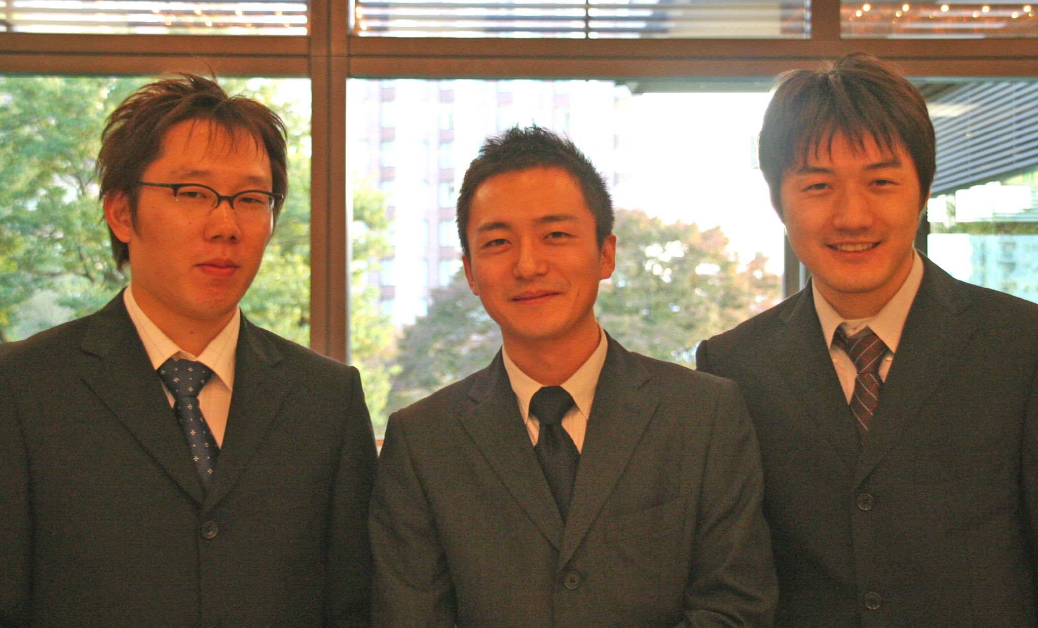 three asian men are wearing suits and ties