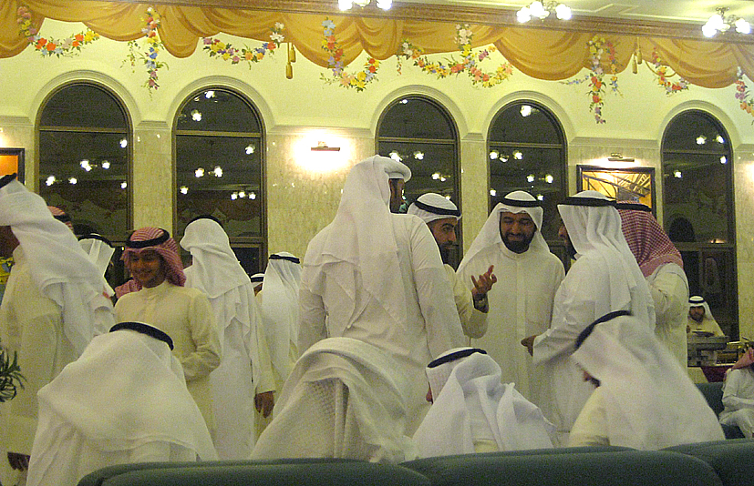 a group of men are walking in front of some windows