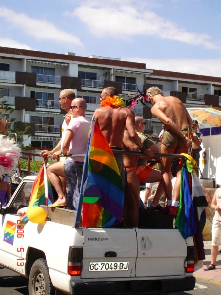 many gay pride members in the back of a truck