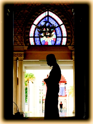 a silhouette of a man looking at his cell phone