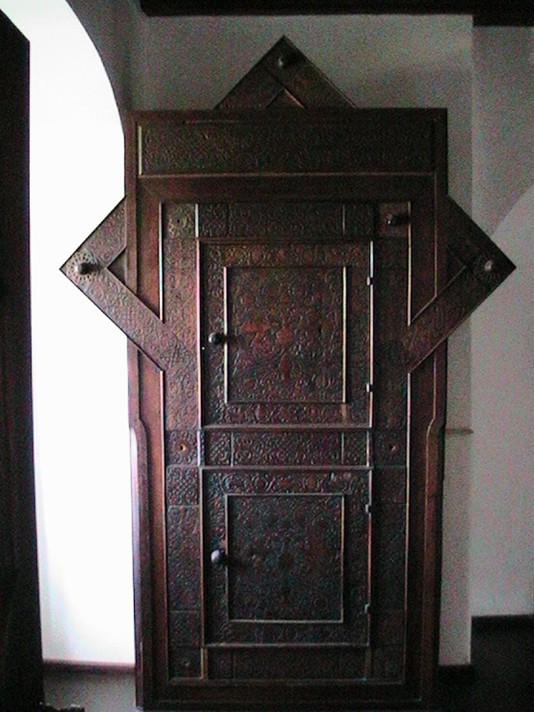 an ornate door next to a window