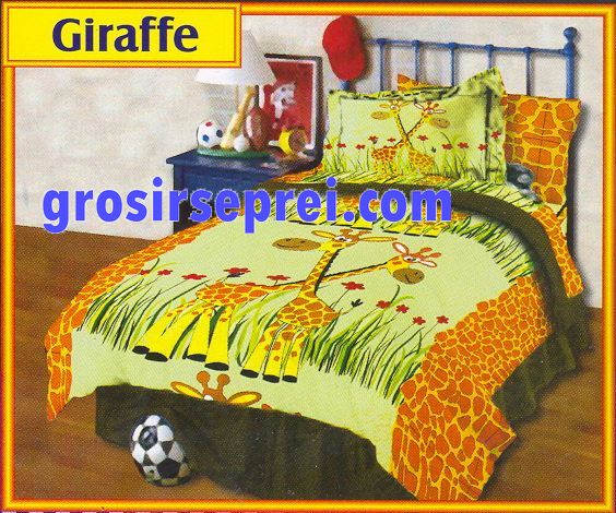 a coverlet with some animal designs and a stuffed animal in it
