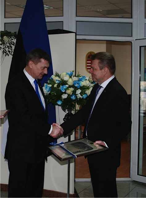 two men shaking hands at an awards ceremony