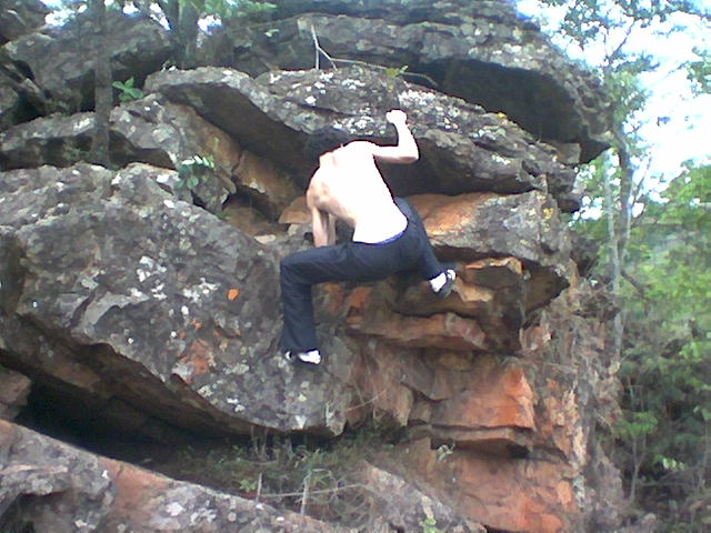 a man with  on climbing up a rock