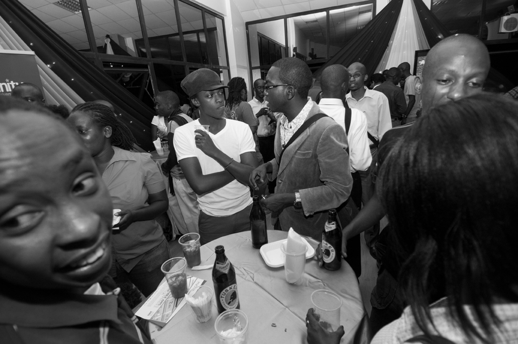 people are gathered around a white table in a busy area