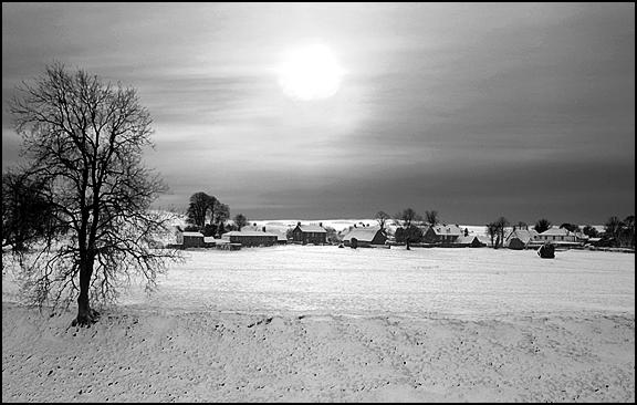 black and white pograph of snow covered field