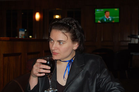 a woman is sitting with a glass in her hand