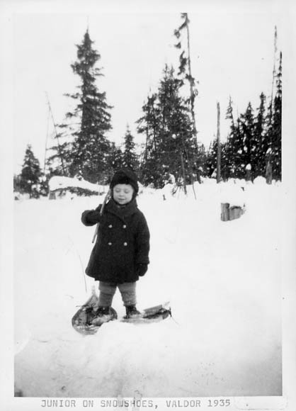a little girl on skis posing in the snow