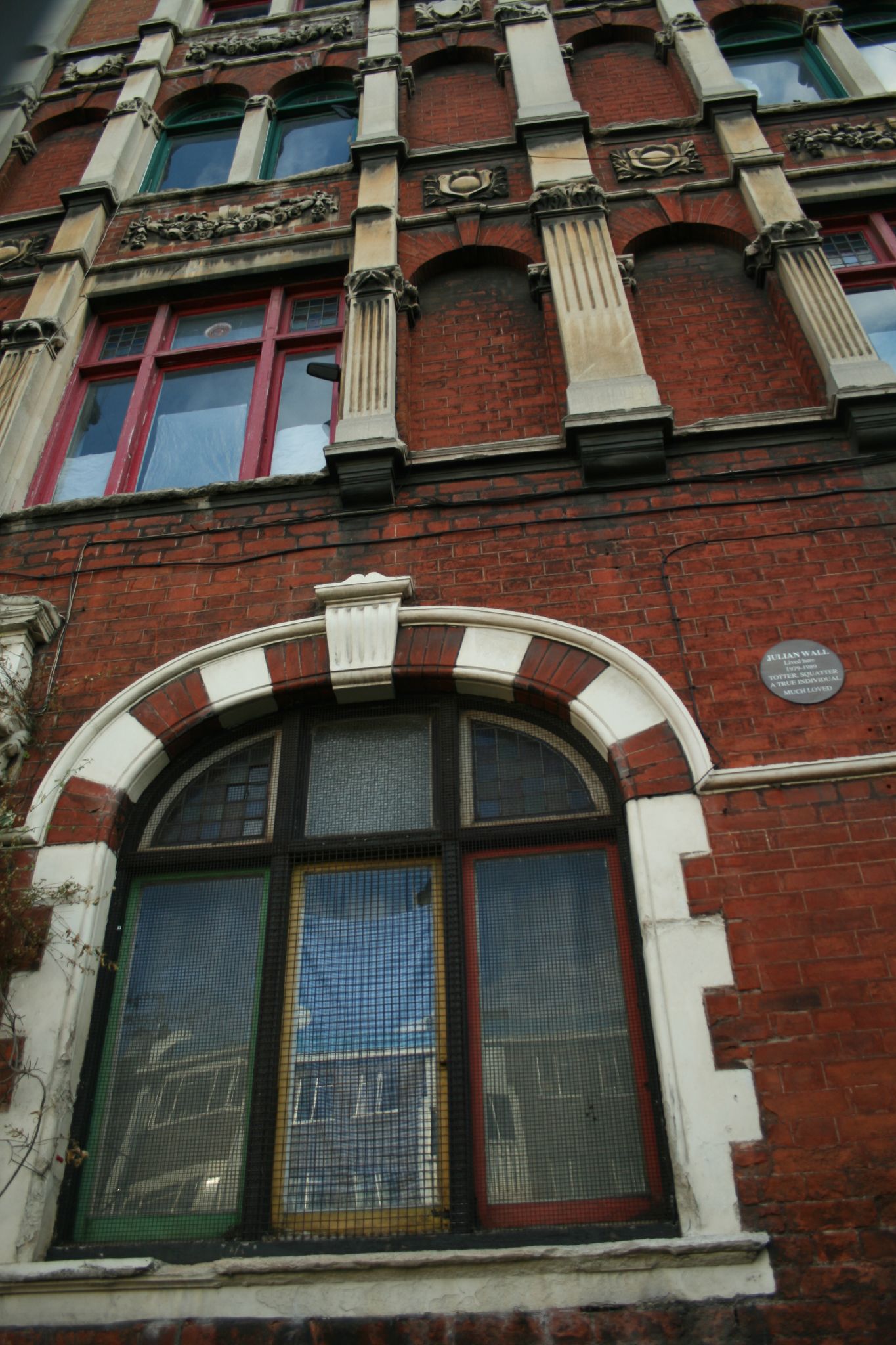 a building with three windows and a clock on the front of it