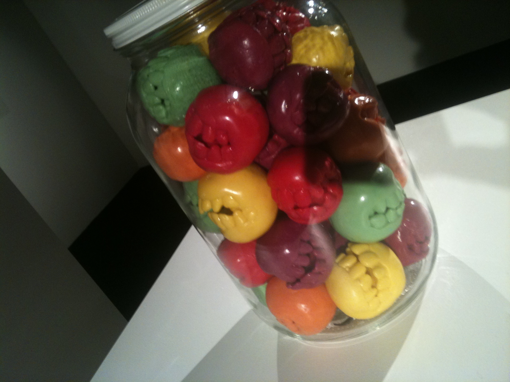 a jar filled with different colored plastic ons