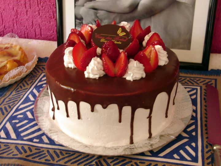 a fancy cake with chocolate and fruit on it