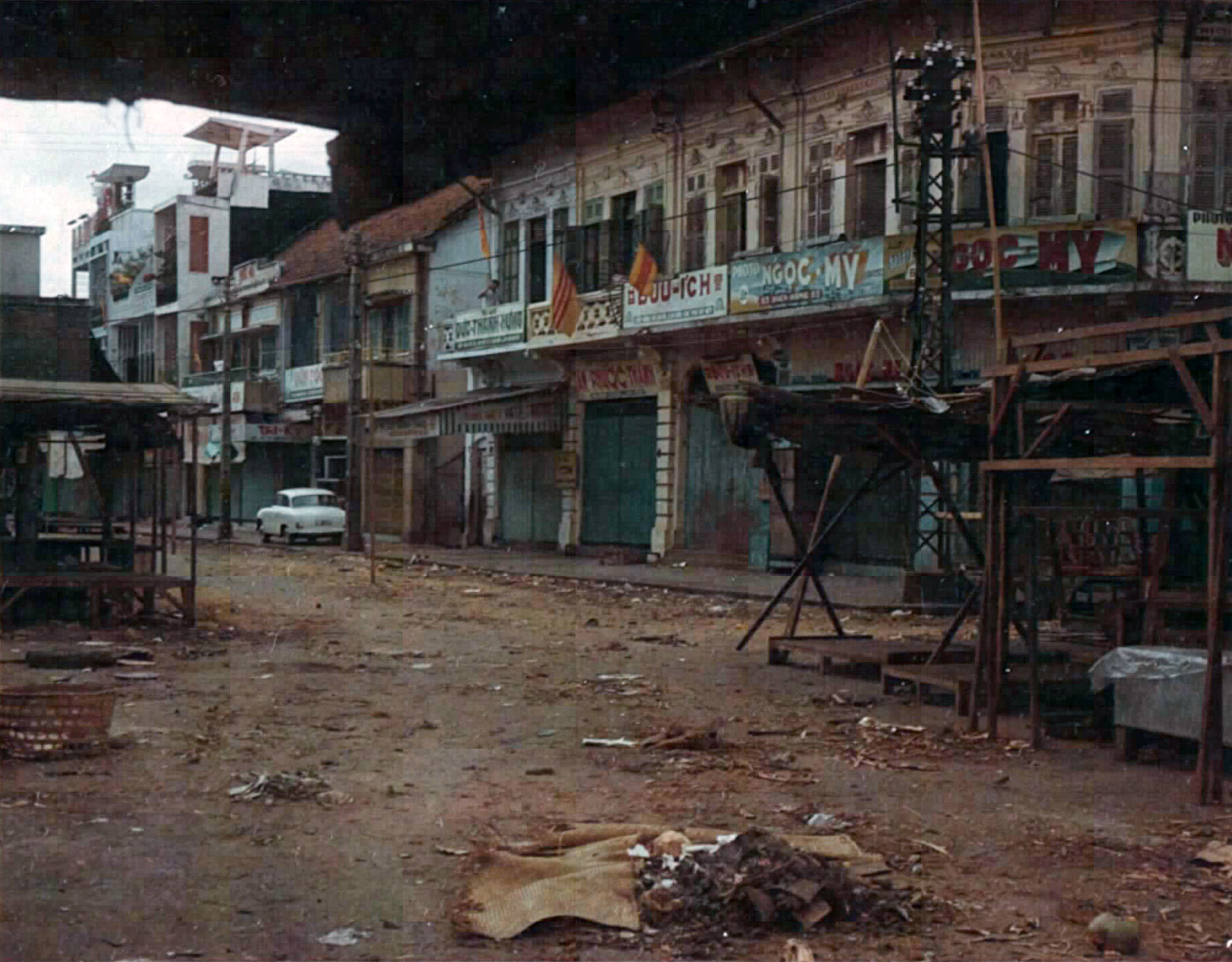 there are many dilapidated buildings along this dirty street