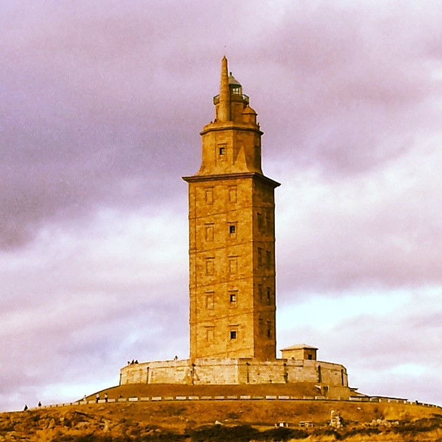 a large tower is on top of a hill