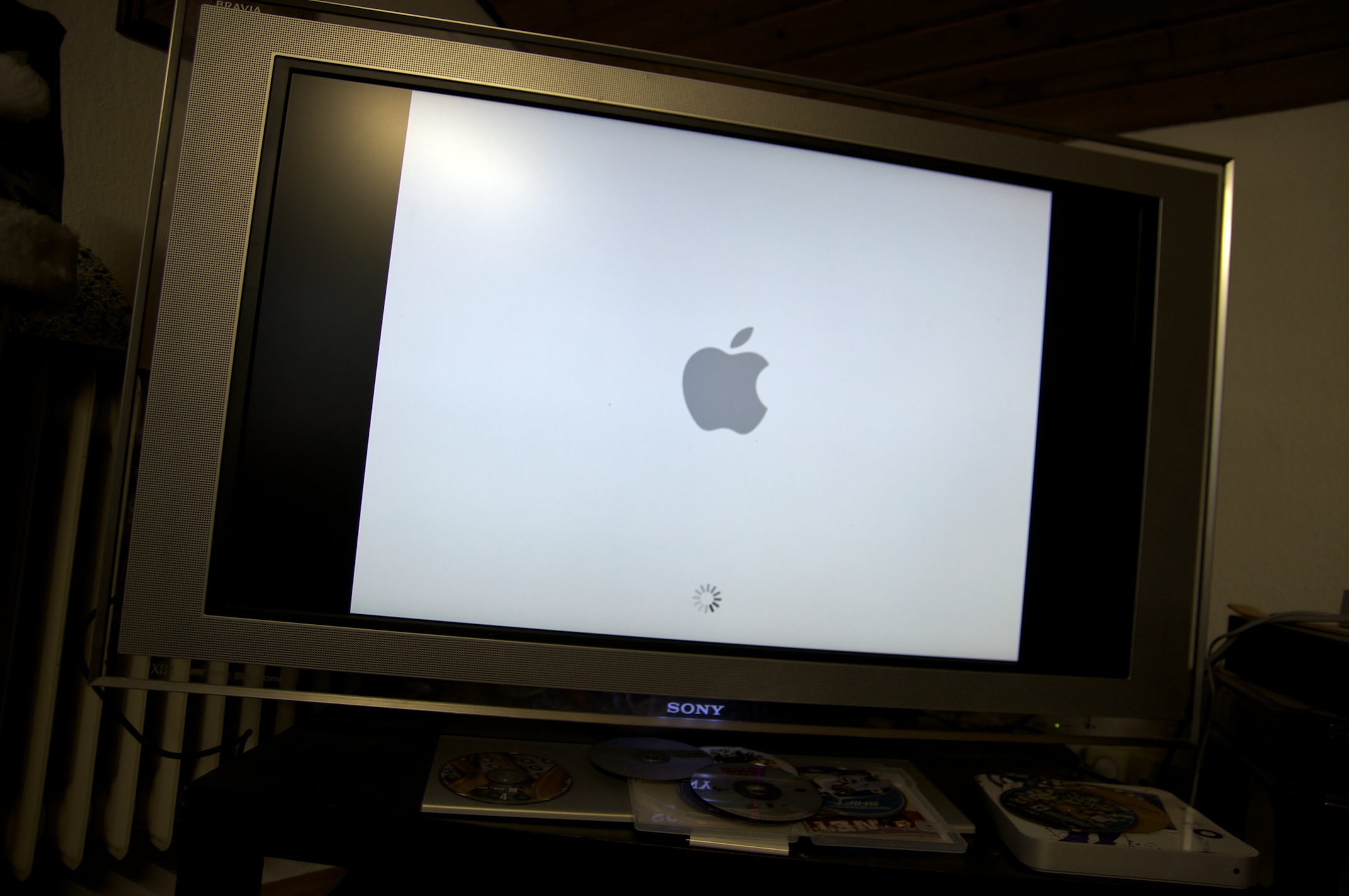 an apple computer sitting on a stand with the screen off