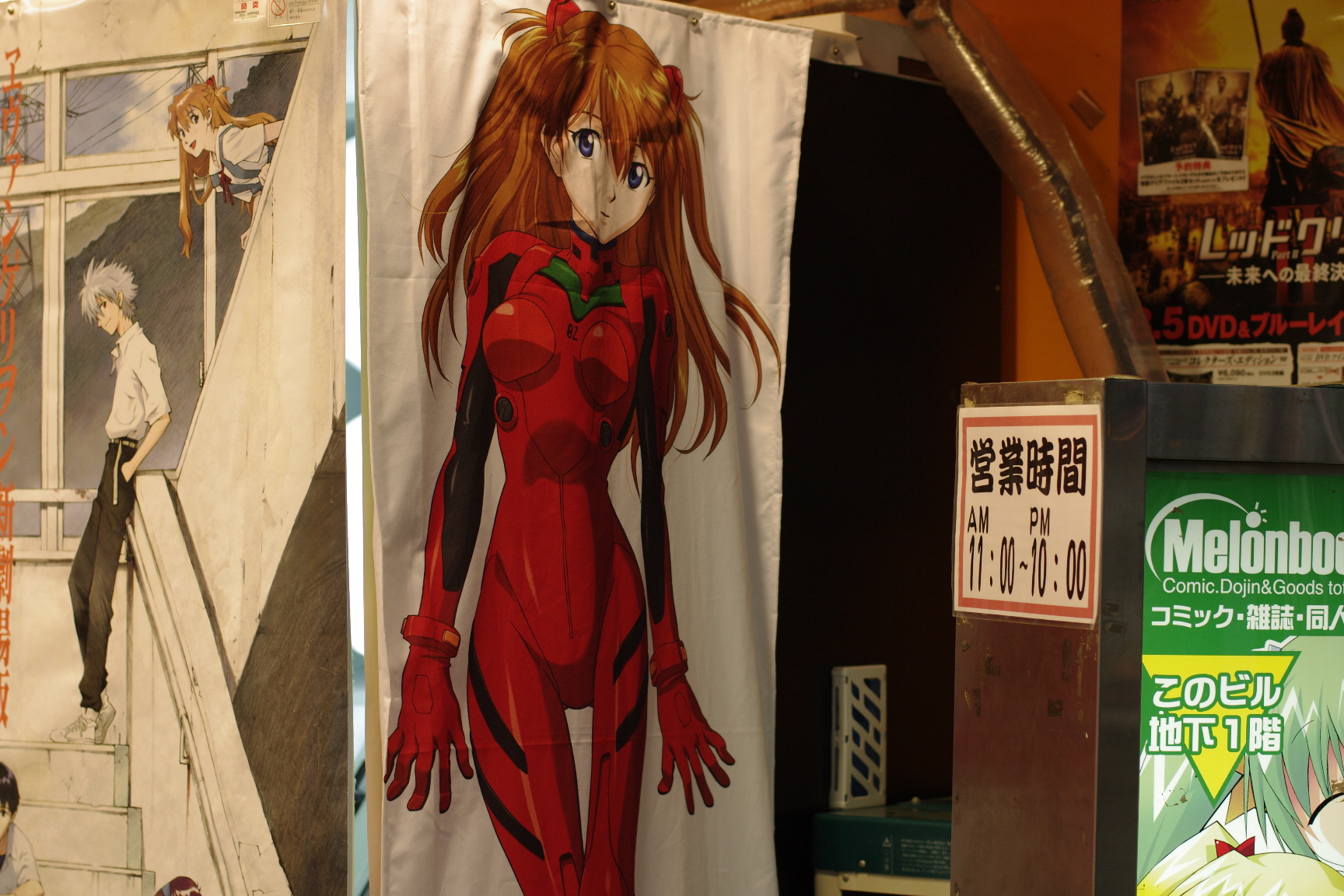 a red haired woman is standing next to poster art