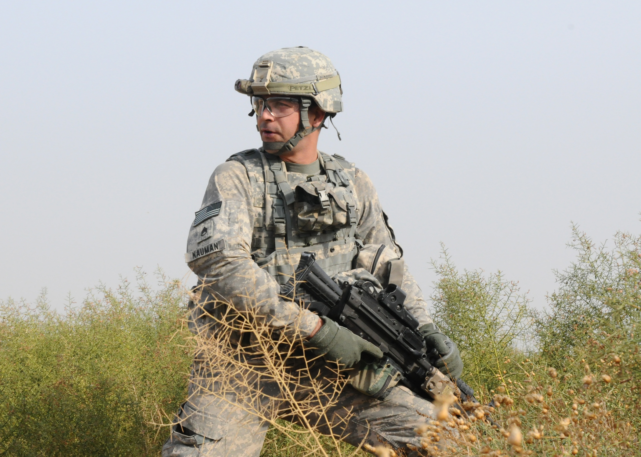 an officer is holding a rifle and looking at soing