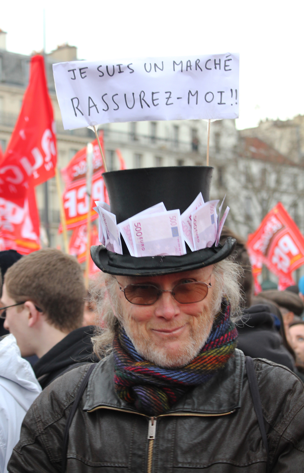 a man in a black hat is wearing a banner