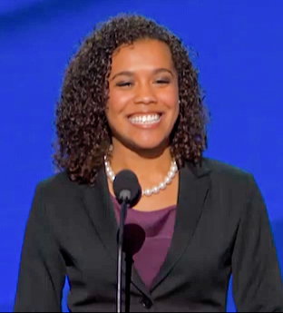 a woman holding a microphone at a convention