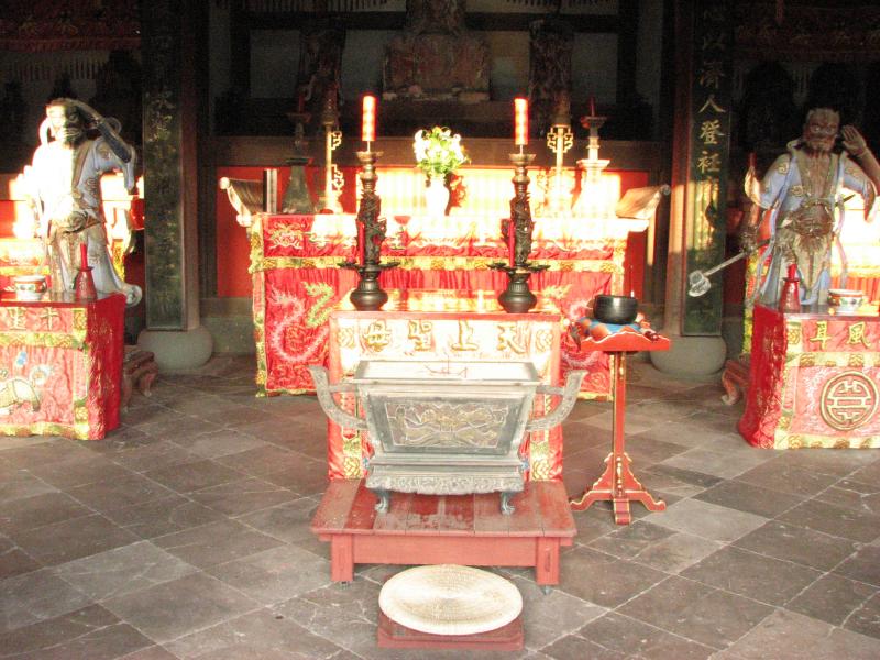 a white altar with statues and candles in it