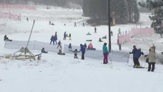 a group of people ski down the snowy slope