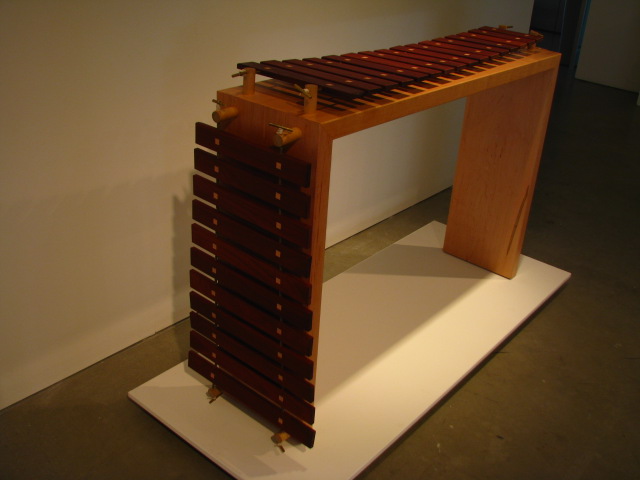 a very modern wooden bench with many drawers