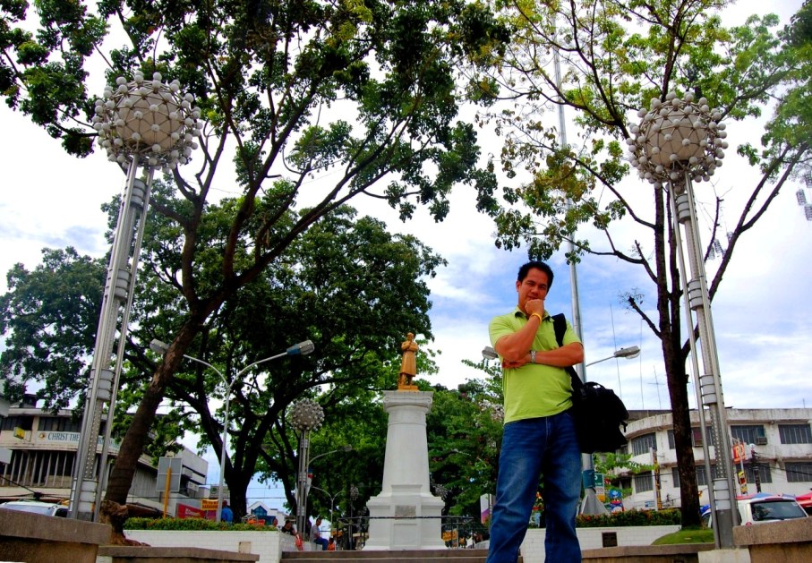 a man standing outside next to some trees