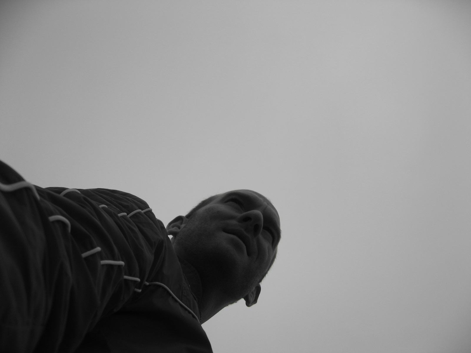 a person looking up in the air during a cloudy day