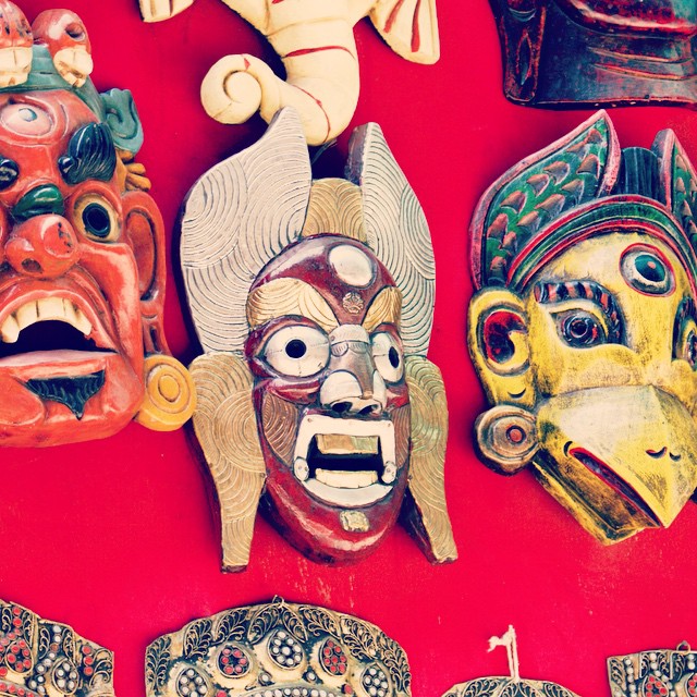 masks on red background of asian style sculpture