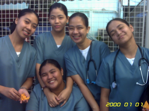 the four young nurses are smiling for a picture