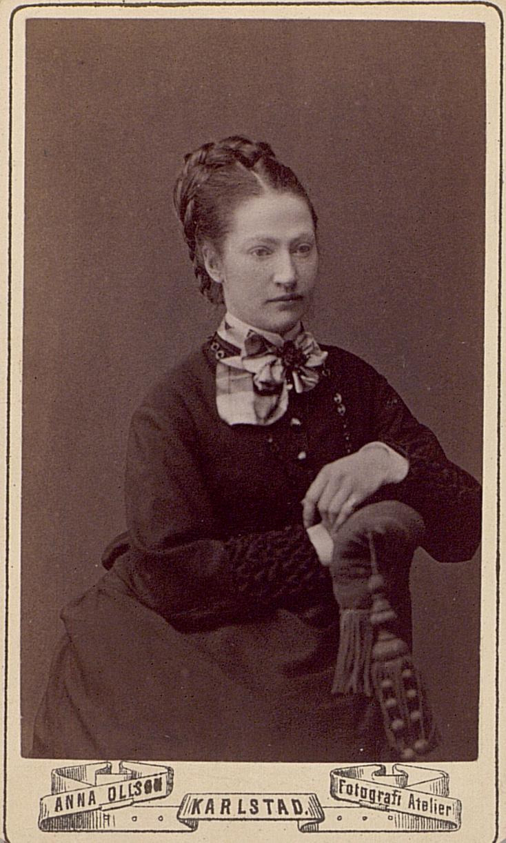 an old black and white po of a woman sitting