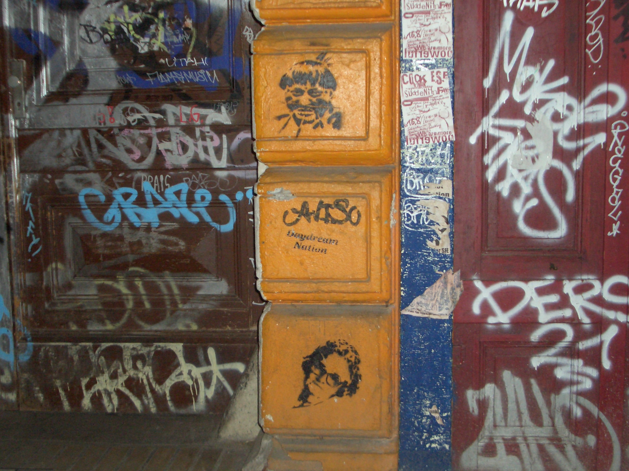 two stacks of wooden crates covered in graffiti