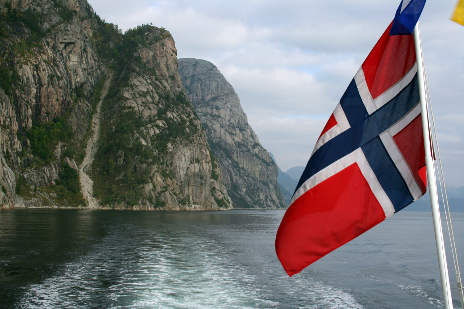 the flag is red white and blue on the side of a boat