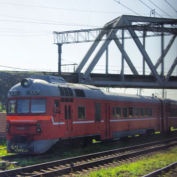 a train traveling on tracks next to a bridge